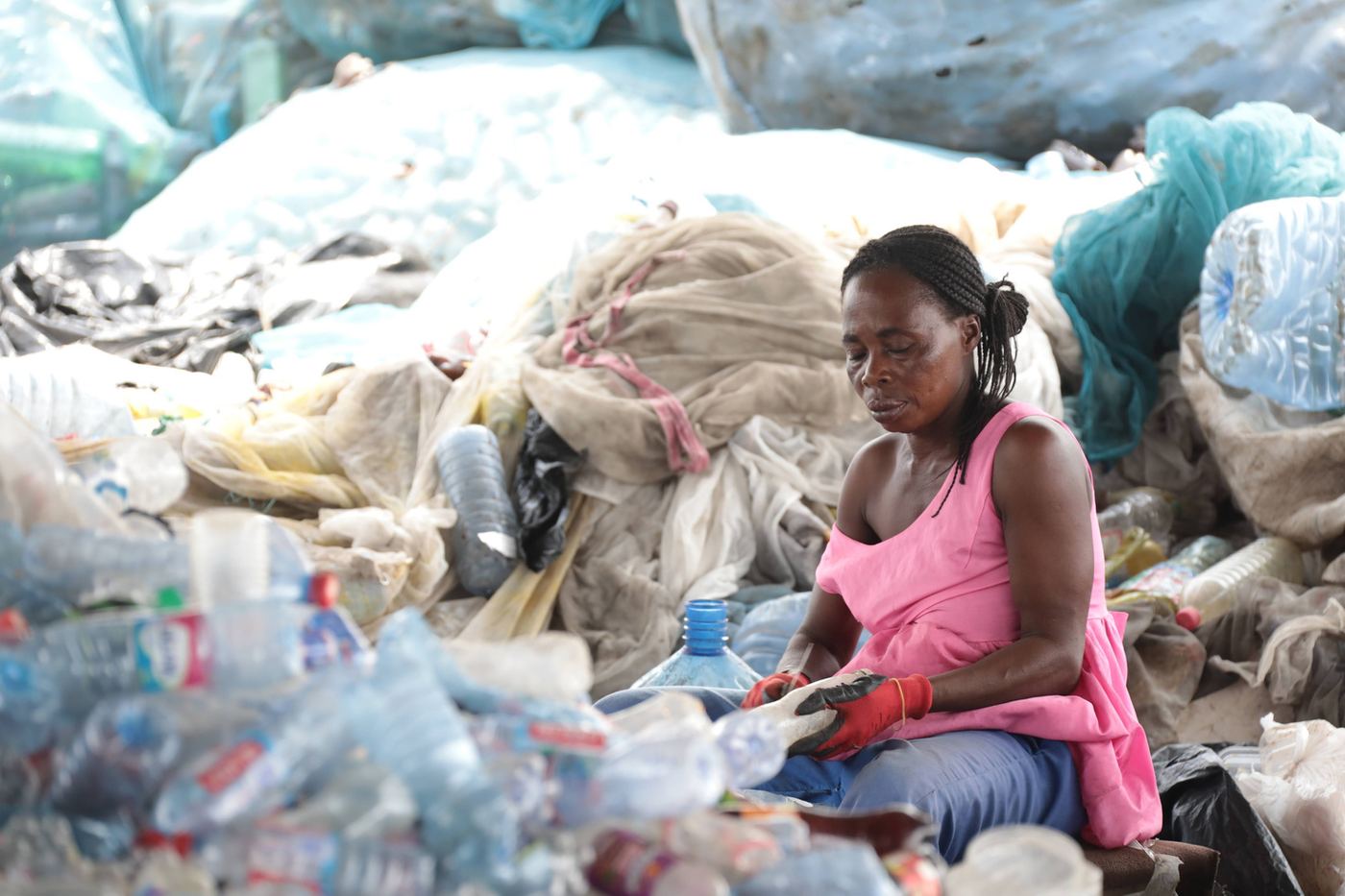 Woman sorting plastic bottles in Accra